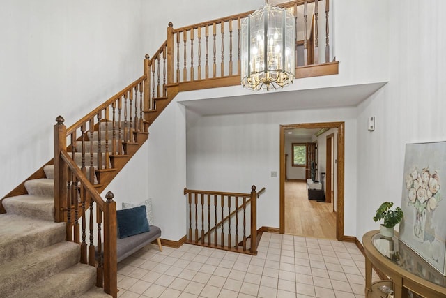 920 Oakwood Ln Unit C, Brookfield, WI 53045 - stairs featuring a chandelier, tile patterned floors, and a high ceiling