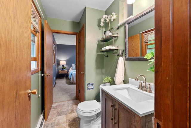 W188N10115 Maple Rd, Germantown, WI 53022 - ensuite bathroom with vanity, stone finish floors, and baseboard heating