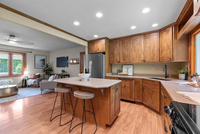 W188N10115 Maple Rd, Germantown, WI 53022 - kitchen with stainless steel fridge, brown cabinetry, stove, open floor plan, and recessed lighting
