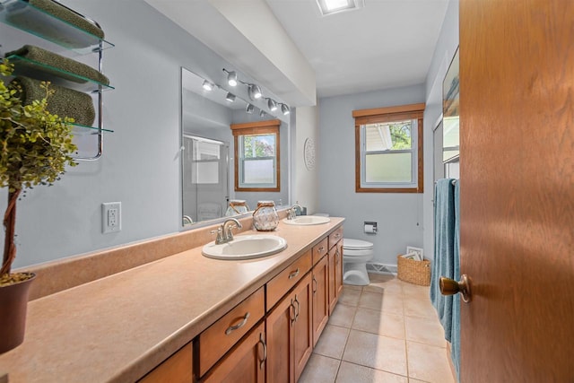 1001 S Matthias St, Appleton, WI 54915 - full bath featuring toilet, double vanity, a shower stall, and tile patterned floors
