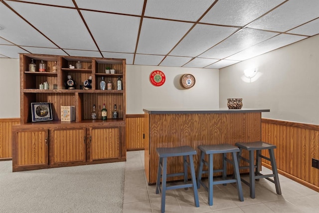 1001 S Matthias St, Appleton, WI 54915 - indoor dry bar with a wainscoted wall, a drop ceiling, wood walls, and light tile patterned floors