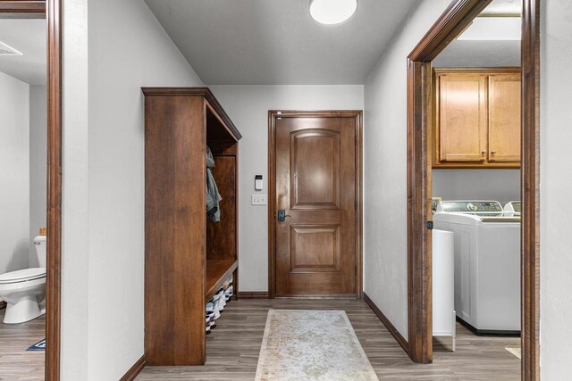 W6708 Prescott Dr, Greenville, WI 54942 - laundry area featuring light wood finished floors, baseboards, cabinet space, and separate washer and dryer