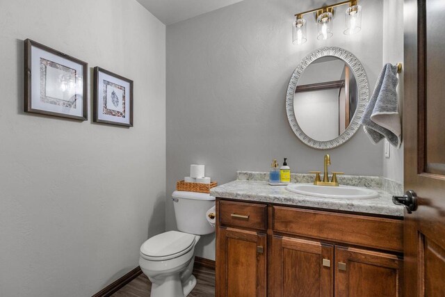 W6708 Prescott Dr, Greenville, WI 54942 - half bath featuring vanity, toilet, wood finished floors, and baseboards