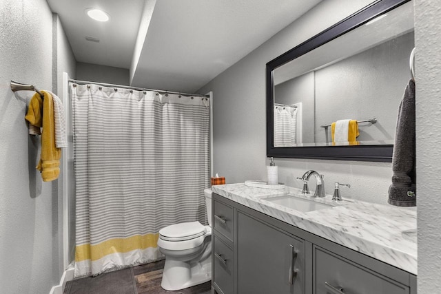 W6708 Prescott Dr, Greenville, WI 54942 - bathroom with vanity, toilet, wood finished floors, a textured wall, and curtained shower