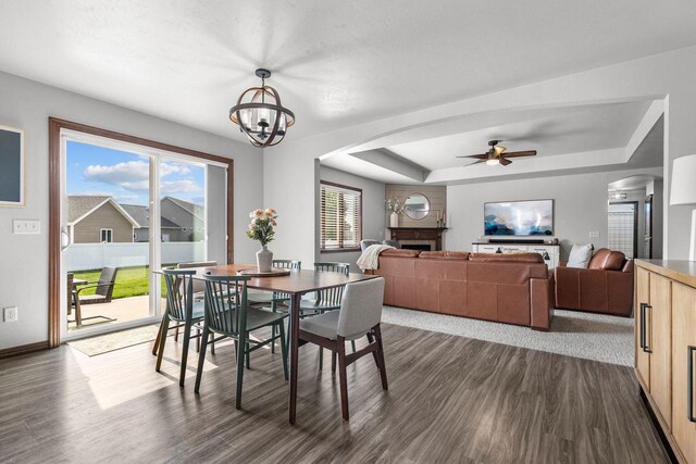 W6708 Prescott Dr, Greenville, WI 54942 - dining area featuring arched walkways, dark wood-style floors, a ceiling fan, a raised ceiling, and baseboards