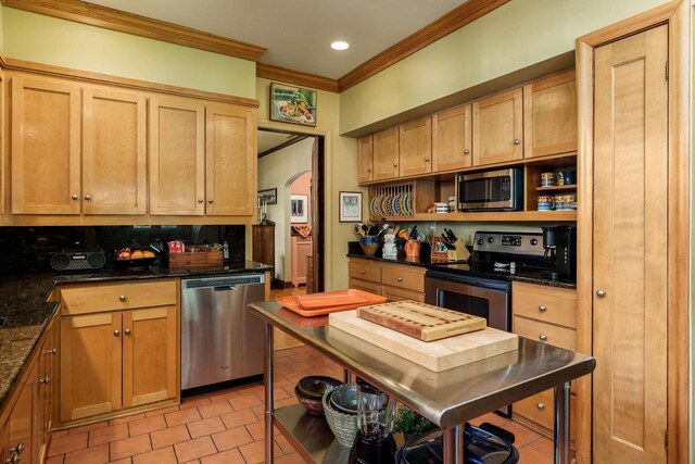 1705 Emerson St, Beloit, WI 53511 - kitchen with stainless steel appliances, crown molding, arched walkways, open shelves, and light tile patterned floors