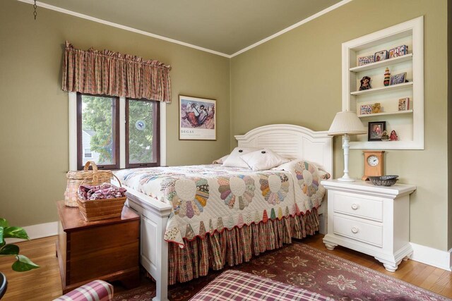 1705 Emerson St, Beloit, WI 53511 - bedroom featuring ornamental molding, wood finished floors, and baseboards