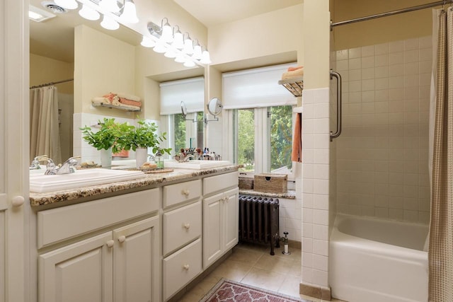 1705 Emerson St, Beloit, WI 53511 - bathroom with radiator, tile patterned flooring, double vanity, and shower / tub combo