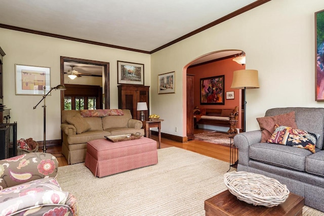1705 Emerson St, Beloit, WI 53511 - living area with wood finished floors, arched walkways, ornamental molding, baseboards, and ceiling fan