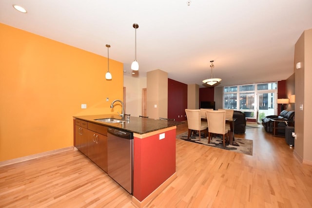 601 E Ogden Ave Unit 411, Milwaukee, WI 53202 - kitchen with dishwasher, a sink, open floor plan, light wood-style floors, and pendant lighting