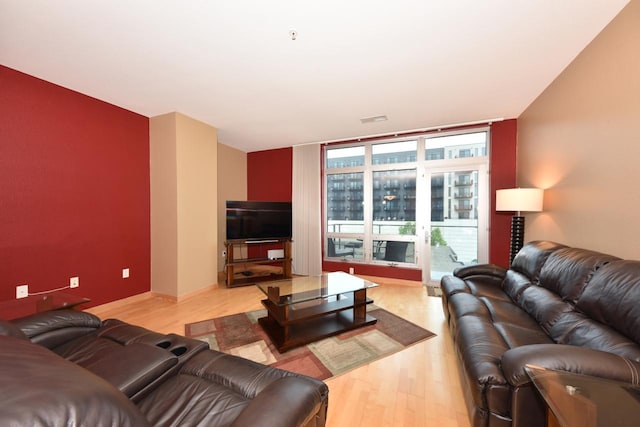 601 E Ogden Ave Unit 411, Milwaukee, WI 53202 - living room featuring light wood-style floors and a wall of windows