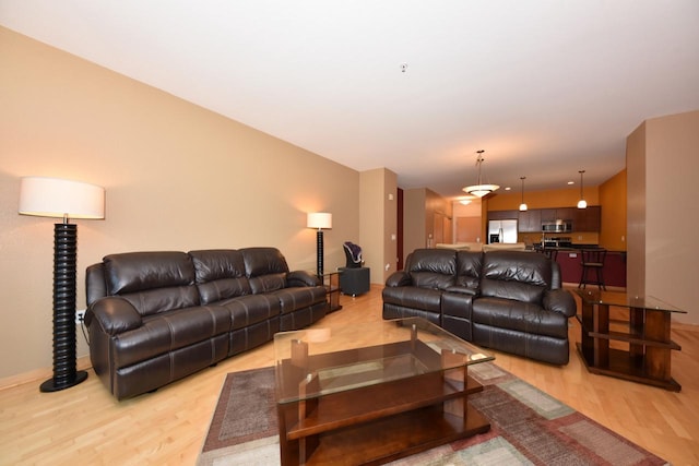 601 E Ogden Ave Unit 411, Milwaukee, WI 53202 - living room featuring light wood finished floors and baseboards