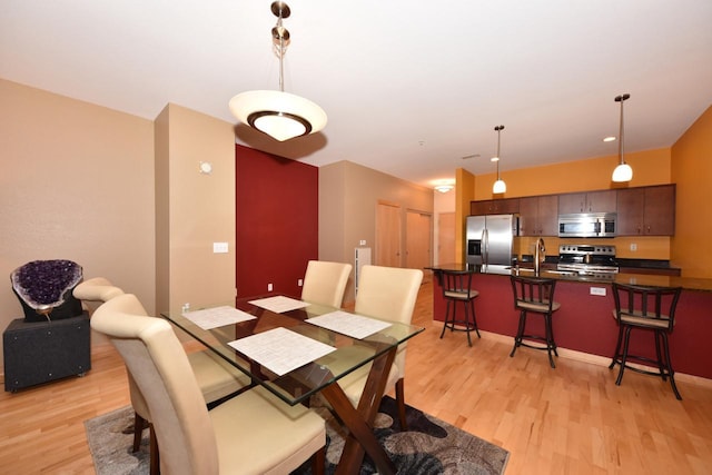 601 E Ogden Ave Unit 411, Milwaukee, WI 53202 - dining room with light wood-type flooring and baseboards