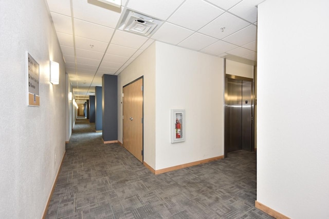 601 E Ogden Ave Unit 411, Milwaukee, WI 53202 - corridor featuring elevator, carpet flooring, a drop ceiling, and baseboards