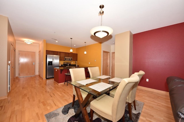 601 E Ogden Ave Unit 411, Milwaukee, WI 53202 - dining room featuring light wood finished floors and baseboards