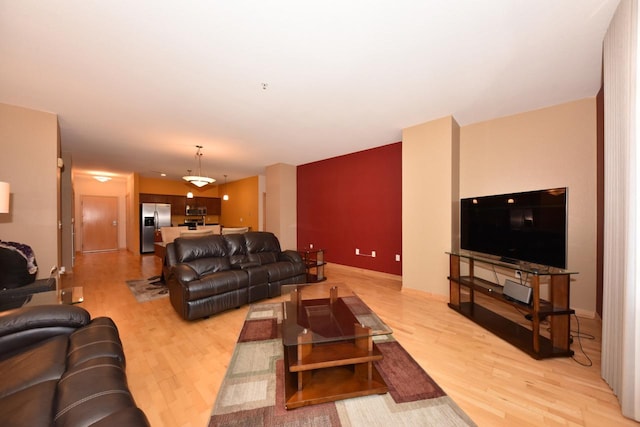 601 E Ogden Ave Unit 411, Milwaukee, WI 53202 - living room with light wood-style flooring and baseboards