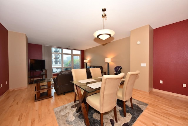 601 E Ogden Ave Unit 411, Milwaukee, WI 53202 - dining room featuring light wood finished floors and baseboards