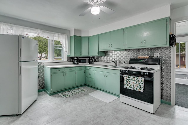 543 N Durkee St, Appleton, WI 54911 - kitchen with freestanding refrigerator, range with gas stovetop, green cabinetry, a sink, and ceiling fan
