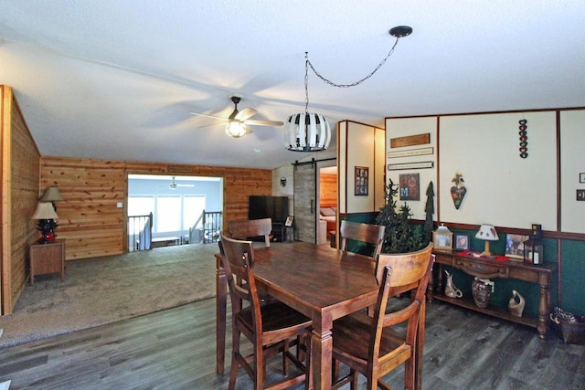 302 Lakeshore Dr, Avoca, WI 53506 - dining room featuring wooden walls, a barn door, ceiling fan, and wood finished floors