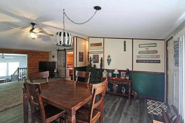 302 Lakeshore Dr, Avoca, WI 53506 - dining space with ceiling fan, a barn door, wood finished floors, and wainscoting