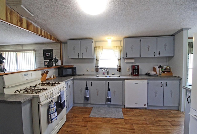 302 Lakeshore Dr, Avoca, WI 53506 - kitchen with white appliances, a textured ceiling, dark wood-type flooring, and dark countertops