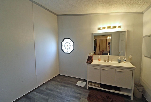 302 Lakeshore Dr, Avoca, WI 53506 - bathroom with ornamental molding, vanity, a textured ceiling, wood finished floors, and ceiling fan