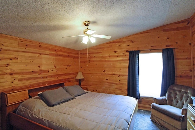 302 Lakeshore Dr, Avoca, WI 53506 - bedroom with vaulted ceiling, multiple windows, wood walls, carpet flooring, and ceiling fan