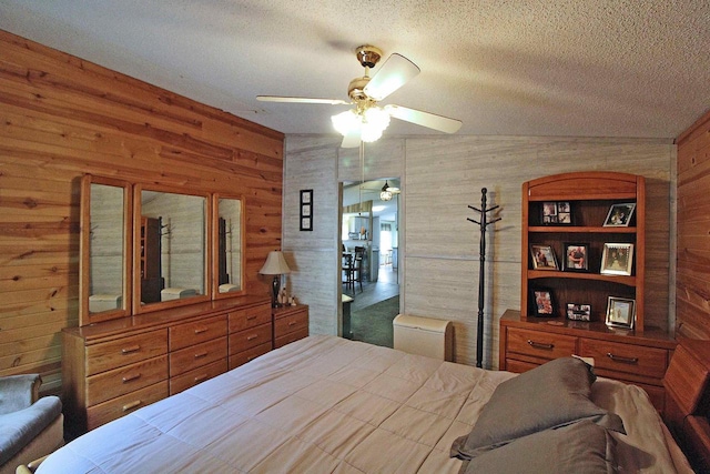 302 Lakeshore Dr, Avoca, WI 53506 - bedroom with wood walls, a textured ceiling, and a ceiling fan