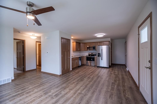 925-935 Green Pastures Trl, Plover, WI 54467 - kitchen featuring appliances with stainless steel finishes, dark wood finished floors, light countertops, and a ceiling fan