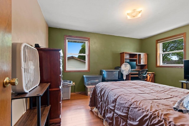 57 Solar Cir, Appleton, WI 54915 - bedroom featuring wood finished floors, multiple windows, and an office area