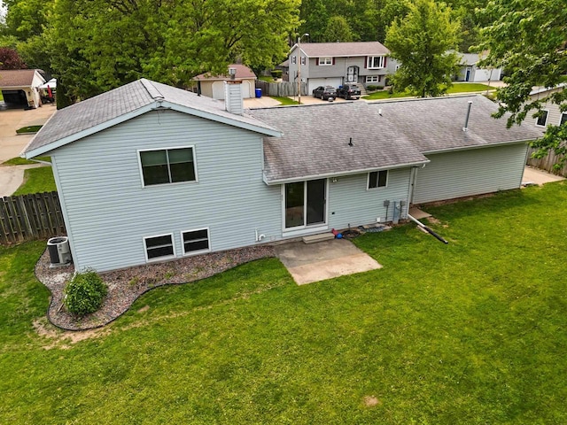 57 Solar Cir, Appleton, WI 54915 - back of property featuring a shingled roof, a chimney, central air condition unit, and a patio area