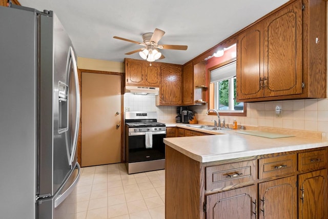 57 Solar Cir, Appleton, WI 54915 - kitchen with appliances with stainless steel finishes, a sink, under cabinet range hood, a peninsula, and brown cabinetry