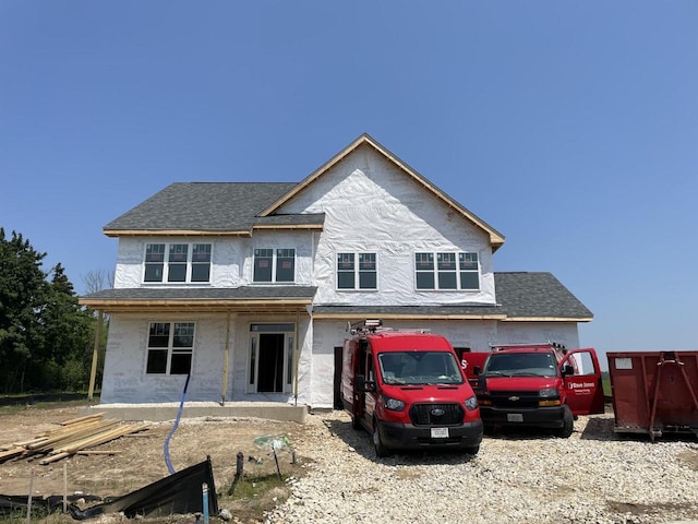9420 W Huntington Dr, Mequon, WI 53097 - view of front of house featuring roof with shingles and stucco siding