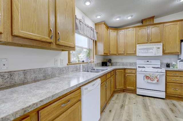 S5472 Mammoth Trl, Baraboo, WI 53913 - kitchen featuring white appliances, a sink, light countertops, light wood-style flooring, and lofted ceiling