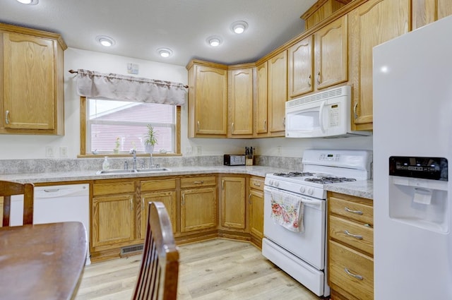 S5472 Mammoth Trl, Baraboo, WI 53913 - kitchen featuring white appliances, a sink, light countertops, and light wood finished floors