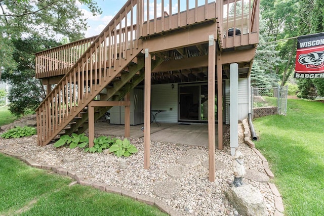 2806 Maple Grove Dr, Madison, WI 53719 - rear view of property featuring stairway, a wooden deck, a lawn, and a patio area