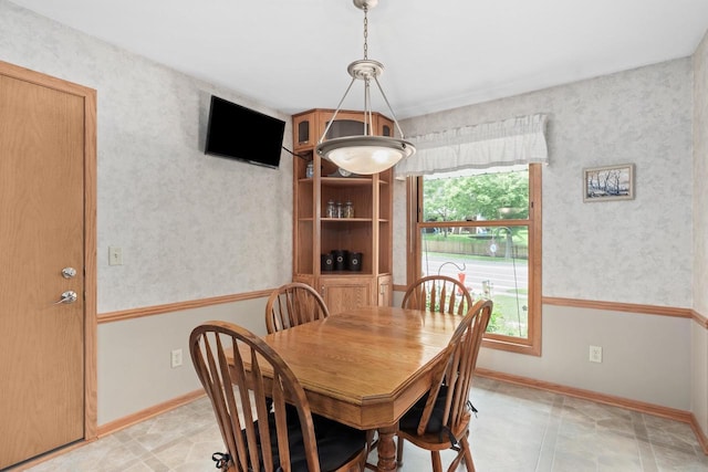 2806 Maple Grove Dr, Madison, WI 53719 - dining area with baseboards, wallpapered walls, and light tile patterned floors