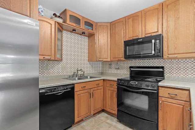 2806 Maple Grove Dr, Madison, WI 53719 - kitchen with black appliances, a sink, light countertops, decorative backsplash, and glass insert cabinets