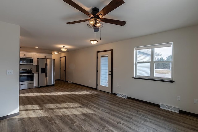 910-920 Green Pastures Trl, Plover, WI 54467 - unfurnished living room with baseboards, ceiling fan, and dark wood-type flooring