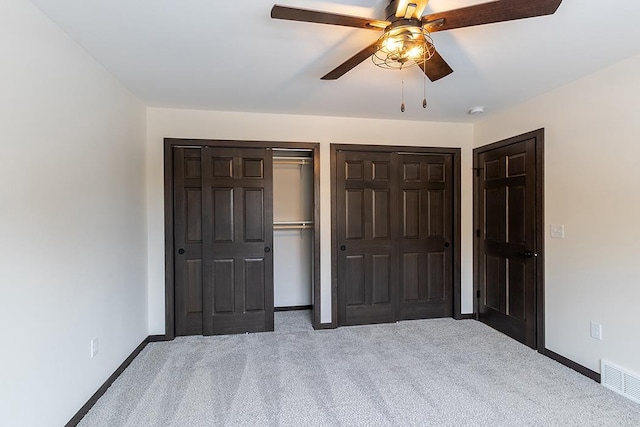 910-920 Green Pastures Trl, Plover, WI 54467 - unfurnished bedroom with carpet floors, baseboards, two closets, and a ceiling fan