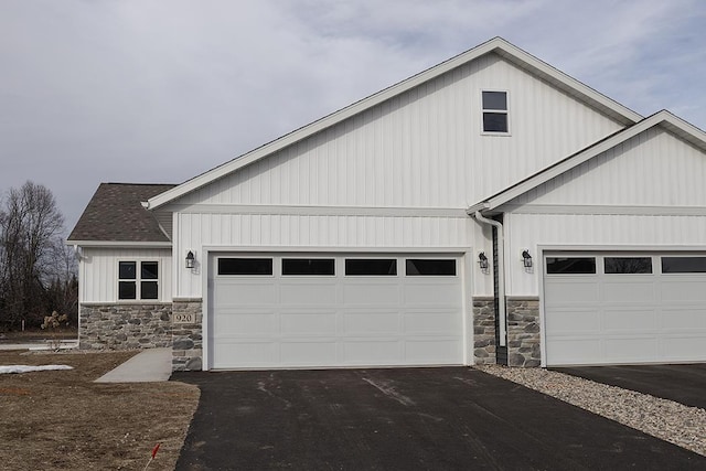 910-920 Green Pastures Trl, Plover, WI 54467 - view of front facade featuring stone siding, asphalt driveway, a garage, and a shingled roof