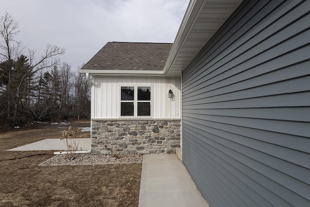 910-920 Green Pastures Trl, Plover, WI 54467 - view of side of home with a shingled roof, stone siding, and board and batten siding