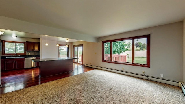 W5183 Biederman Dr, Johnson Creek, WI 53038 - kitchen featuring stainless steel dishwasher, dark wood-style flooring, plenty of natural light, and baseboard heating