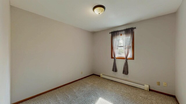 W5183 Biederman Dr, Johnson Creek, WI 53038 - empty room featuring a baseboard radiator, carpet flooring, and baseboards