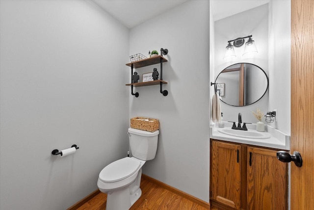 1529 Vogt Dr, West Bend, WI 53095 - bathroom with toilet, wood finished floors, vanity, and baseboards