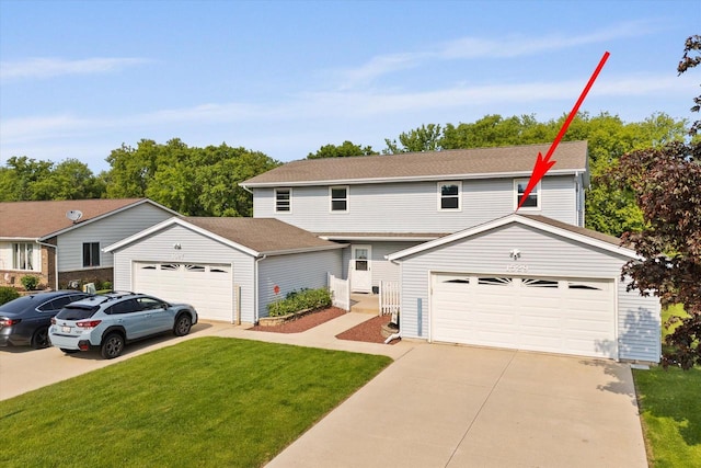1529 Vogt Dr, West Bend, WI 53095 - view of front of house featuring a front yard, concrete driveway, and an outdoor structure