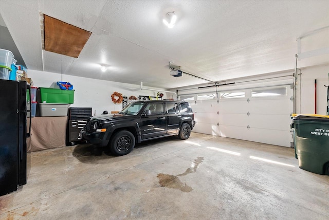 1529 Vogt Dr, West Bend, WI 53095 - garage featuring freestanding refrigerator and a garage door opener