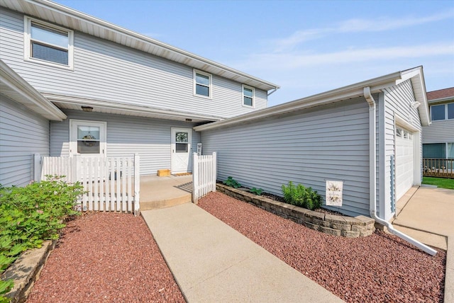 1529 Vogt Dr, West Bend, WI 53095 - rear view of property with a garage and driveway