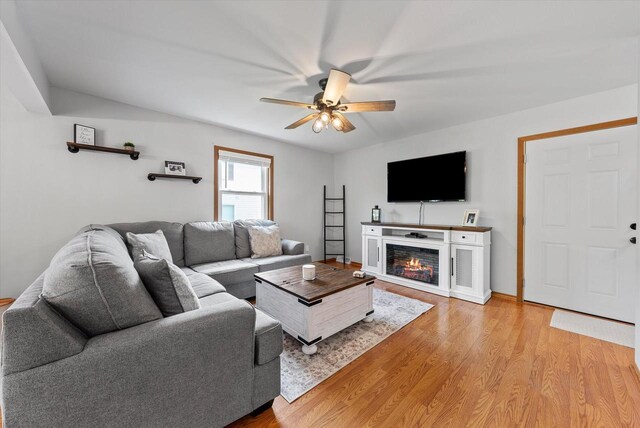 1529 Vogt Dr, West Bend, WI 53095 - living room with a ceiling fan, light wood-style floors, and a glass covered fireplace