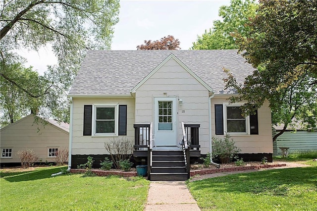 121 Pear St, Chippewa Falls, WI 54729 - view of front of house featuring a shingled roof and a front lawn